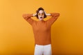 Charming woman with shocked face epxression touching her head. Studio shot of emotional european girl in trendy woolen