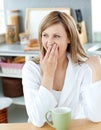 Charming woman yawning while drinking coffee Royalty Free Stock Photo