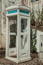 Charming wood telephone booth at a cobblestone alley