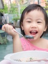 Charming 2-3 years old cute baby Asian girl, little toddler child enjoying her breakfast Royalty Free Stock Photo