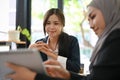 Charming Asian businesswoman or female manager in the meeting with her team Royalty Free Stock Photo