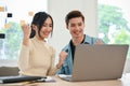 Charming Asian female office worker and her colleague celebrating campaign winning together Royalty Free Stock Photo