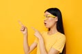 Charming young Asian woman hands gesture emotions cropped view yellow background unaltered Royalty Free Stock Photo