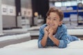 Charming young boy at the furniture store