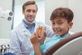 Charming young boy getting teeth checkup at the dentist