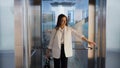 Charming young business lady in the Elevator in the business center. A young woman Royalty Free Stock Photo