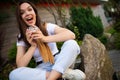 Charming young business woman having coffee break sitting on cafe terrace Royalty Free Stock Photo