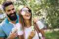 Charming young couple sitting on bench in the park Royalty Free Stock Photo