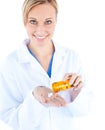 Charming young doctor holding pills