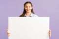 Portrait of a beautiful girl holding a white board Royalty Free Stock Photo