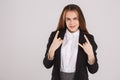 A beautiful young woman showing rock sign on a gray background. Hands gestures concept Royalty Free Stock Photo