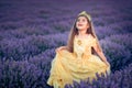 Gorgeous young girl with queen crown amazed by the sky in the lavender field at sunset
