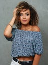 Charming young lady with exotic appearance, woman with curly hairstyle in studio