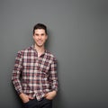 Charming young man in checkered shirt smiling Royalty Free Stock Photo