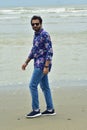 Charming, young, mature male walking on beach