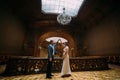 Charming young newlywed pair dancing at the background of vintage victorian mansion royal wooden interior Royalty Free Stock Photo