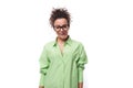 charming young slender female model advertiser dressed in a light green shirt on a white background with copy space