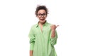 charming young slender female model advertiser dressed in a light green shirt on a white background with copy space