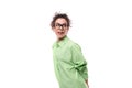 charming young slender female model advertiser dressed in a light green shirt on a white background with copy space