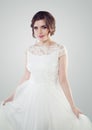 Charming young woman bride in white dress, studio portrait Royalty Free Stock Photo