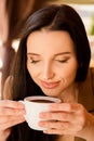 Charming young woman enjoying aroma coffee in cafe Royalty Free Stock Photo