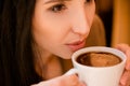 Charming young woman enjoying coffee Royalty Free Stock Photo