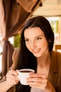 Charming young woman enjoying coffee in cafe Royalty Free Stock Photo