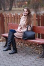 Charming young woman with long brown hair in a beige coat Royalty Free Stock Photo