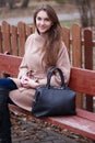 Charming young woman with long brown hair in a beige coat Royalty Free Stock Photo