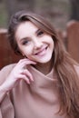 Charming young woman with long brown hair in a beige coat Royalty Free Stock Photo