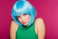 Charming young woman posing in blue wig, isolated
