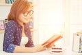 Charming young woman sitting reading book in the cafe Royalty Free Stock Photo