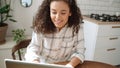 Charming young woman typing on laptop computer at home. Royalty Free Stock Photo