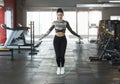 Pretty young woman using jump rope in sports club Royalty Free Stock Photo