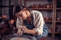 Stylish artisan working with pottery at the ceramic workshop. Handmade products. Royalty Free Stock Photo
