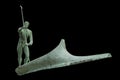 Charon transports the souls of dead people by boat across the Styx River. Ancient mythology. Antique statue isolated on black Royalty Free Stock Photo