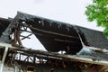 A charred, black wall of a log house after a fire. Royalty Free Stock Photo