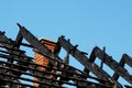 Charred burnt black wooden roof structure after house fire