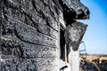 Charred and burnt siding from a building structure fire. Royalty Free Stock Photo