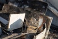 Charred PC system unit among the ruins after a fire. Royalty Free Stock Photo