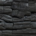 Charred wooden surface with detailed texture, showcasing deep Royalty Free Stock Photo