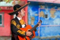 Charro Mariachi playing guitar Mexico houses