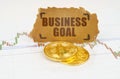 On the chart with quotes, there are bitcoins and there is a sign with the inscription - BUSINESS GOAL