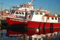 Charter fishing boats are moored at a commercial dock