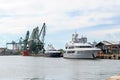 The charter yacht Mustique in the port of Varna, Bulgaria. Two luxury yachts moored at the pier on a spring day. Expensive super Royalty Free Stock Photo