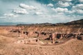 Charyn Grand Canyon with clouds and sun red orange stone Martian landscape