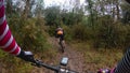 Chasing a rider in a mountain bike race in a single track forest trail Royalty Free Stock Photo