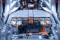 Chassis of the electric car with powertrain and power connections closeup. Blue toned. EV car drivetrain at maintenance. Royalty Free Stock Photo