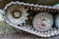 Chassis of tracked military equipment. Metal tracks of a tracked vehicle in dried mud Royalty Free Stock Photo