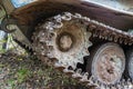Chassis of tracked military equipment. Metal tracks of a tracked vehicle in dried mud. Cogwheel of a combat vehicle Royalty Free Stock Photo